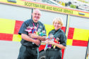 Iain Brooks, Crew Manager with the Scottish Fire Service and Inspector Judy Hill of Police Scotland.