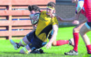 Gordonians’ Cameron Hughes scores a try under pressure from                                     Haddington’s Cammy Simpson