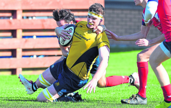 Gordonians’ Cameron Hughes scores a try under pressure from                                     Haddington’s Cammy Simpson