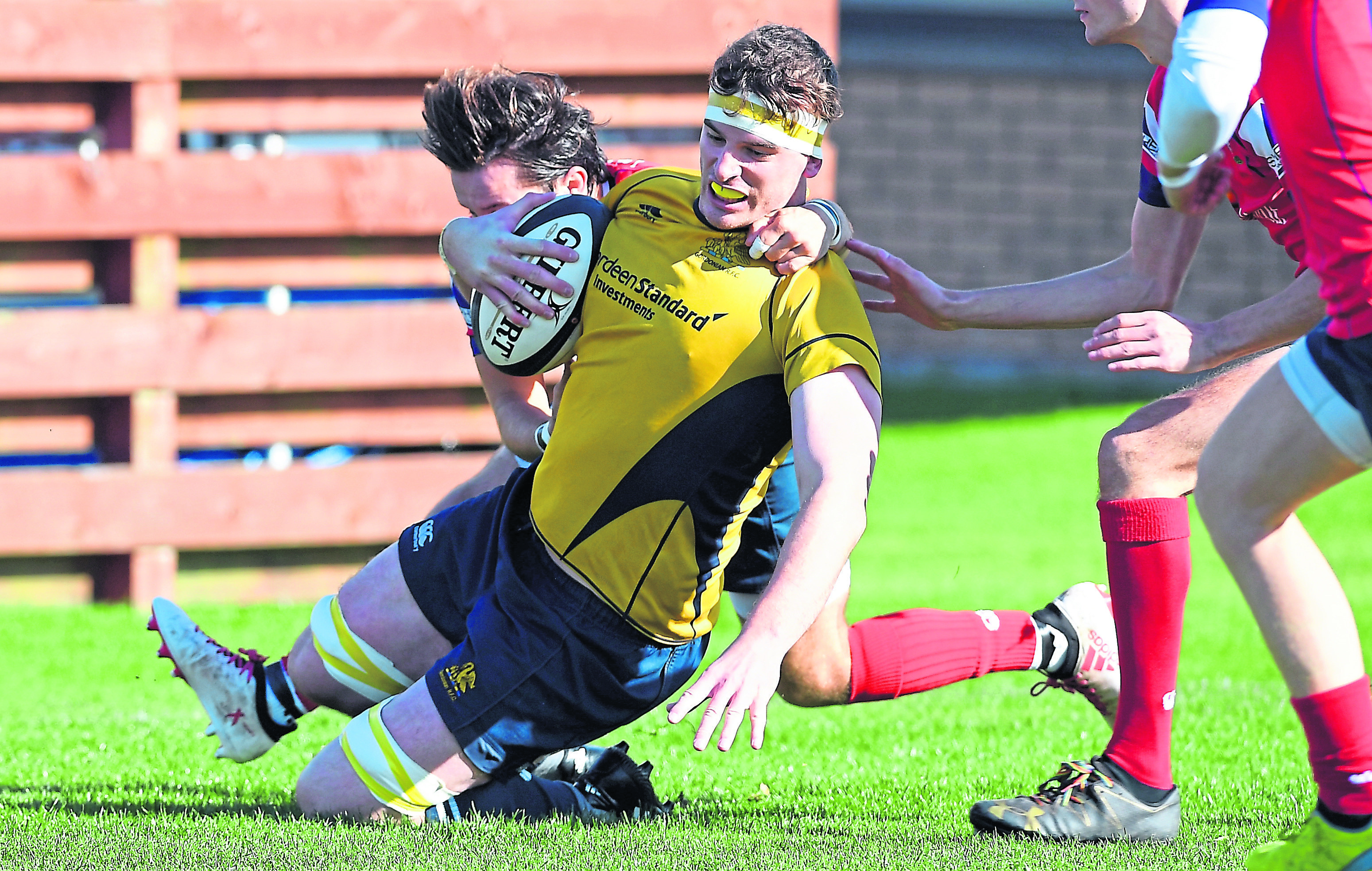 Gordonians’ Cameron Hughes scores a try under pressure from                                     Haddington’s Cammy Simpson