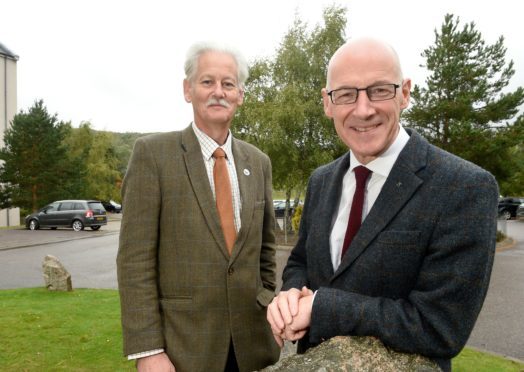 Deputy First Minister John Swinney with Peter Argyle, Convener of the Cairngorms National Park Authority outside the conference at Aviemore. Picture by Sandy McCook