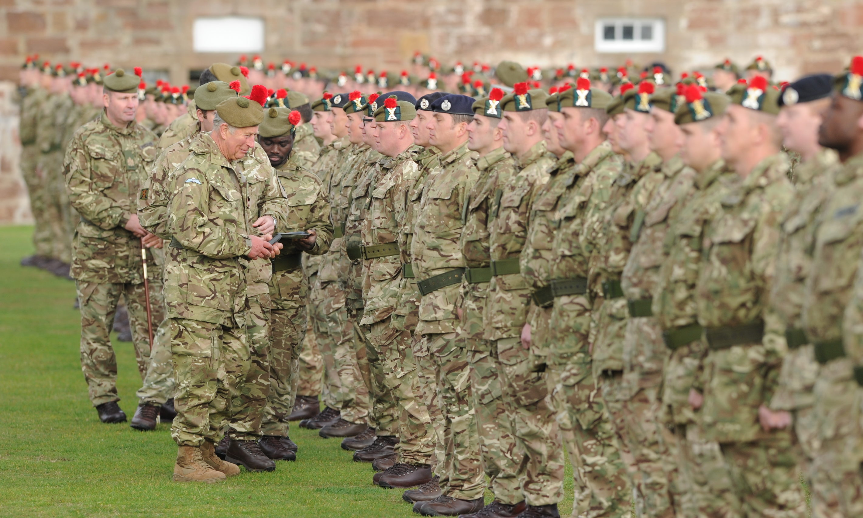The Duke of Rothesay presenting 3 Scots soldiers with medals to commemorate their tour of Iraq at Fort George.