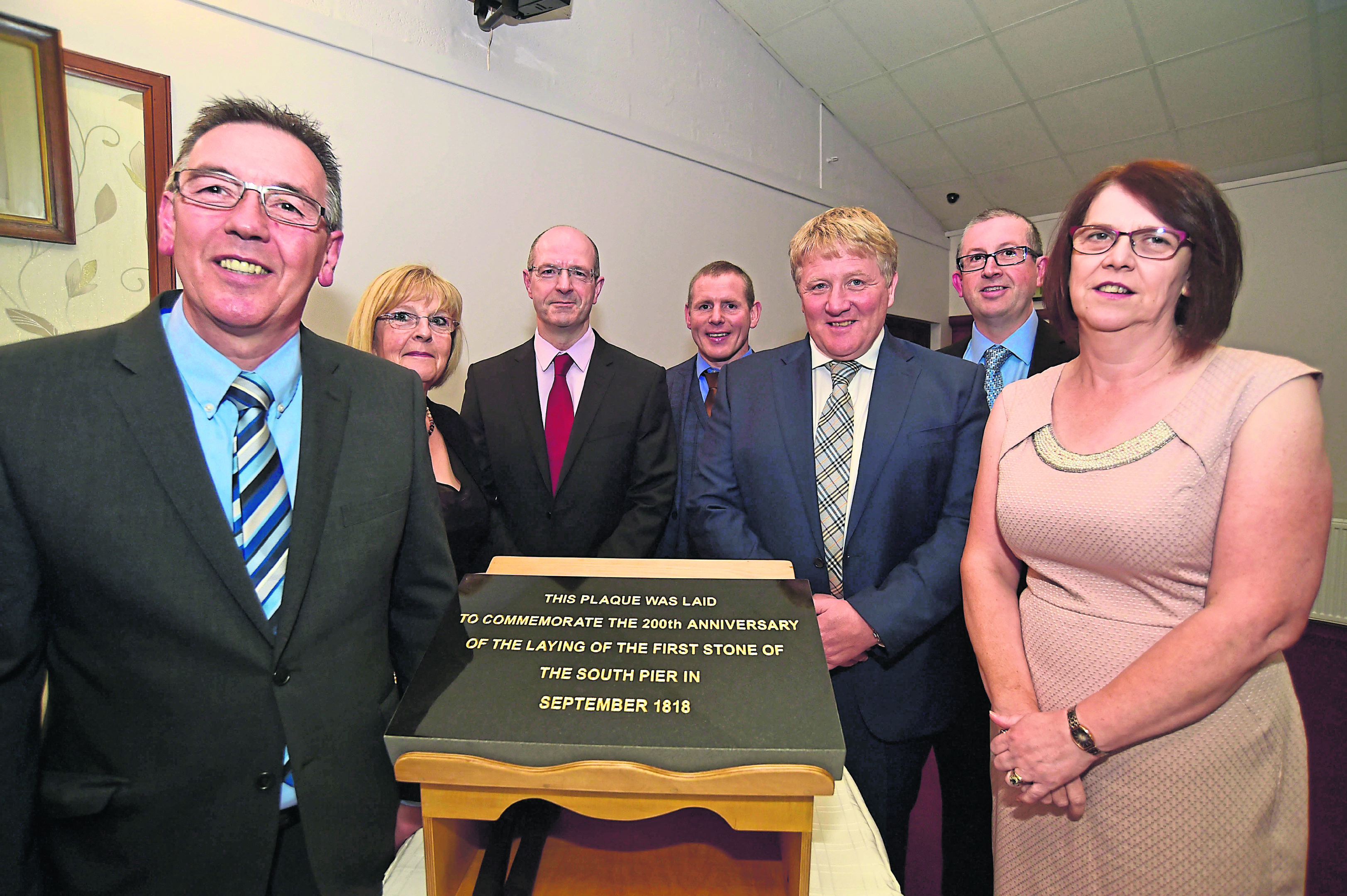 Fraserburgh Harbour Board Members (L To R)  Tommy Boyle, Doreen Mair, Michael Murray, John Murison, David Milne, Darren Broadley and Jill Smith with the plaque commemorating the 200th anniversary of the harbour construction.