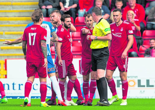 Aberdeen's Michael Devlin (L) is sent off by referee Craig Thomson.