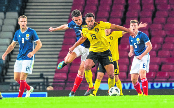 Scotland's John McGinn (left) battles with Belgium's Mousa Dembele.