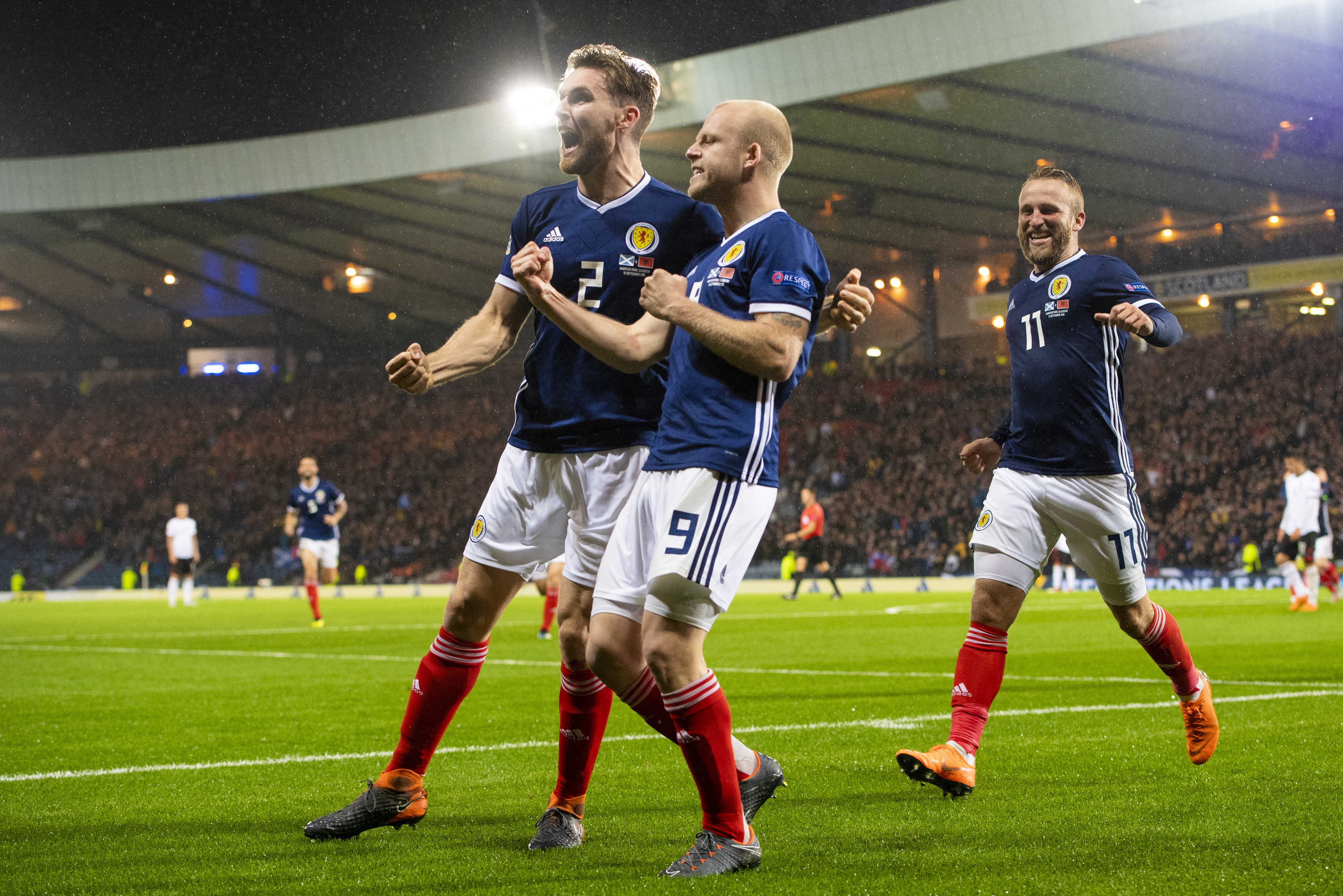 Steven Naismith celebrates with Stephen O'Donnell and Johnny Russell after giving Scotland the lead against Albania.
