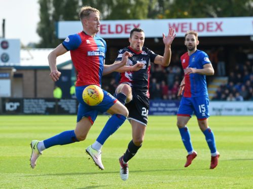 Caley Thistle's Coll Donaldson challenges Don Cowie of Ross County.