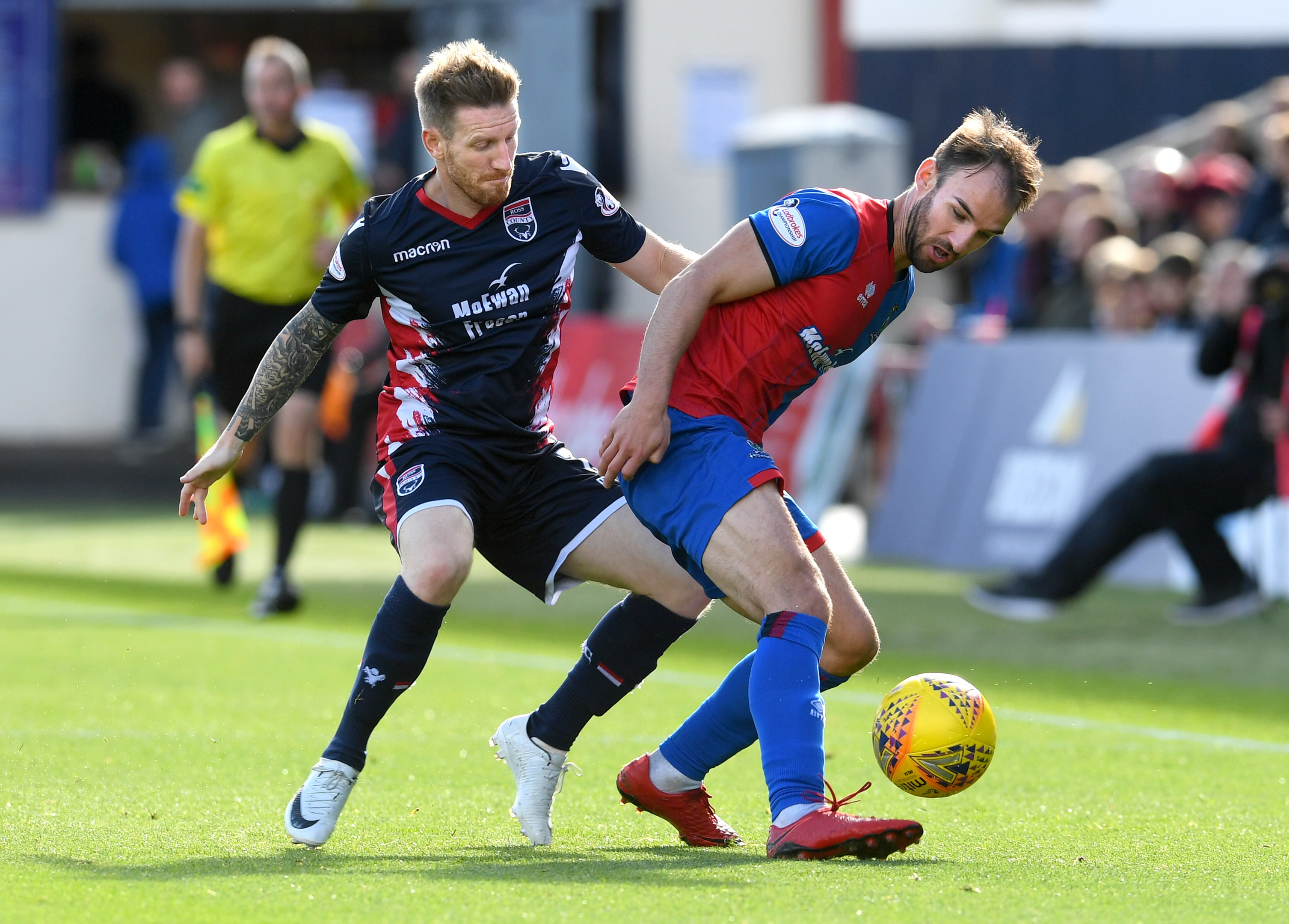 Inverness's Sean Welsh holding off Ross Countys Michael Gardyne.