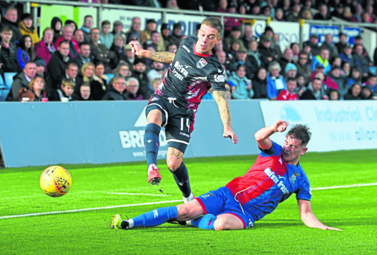 Ross Countys Josh Mullin (L) in action against Inverness's Aaron Doran