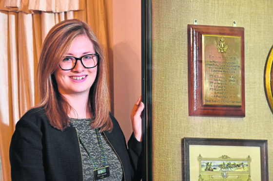 Gordon Highlanders Museum curator Ruth  Cox next to the Roll of Honour plaque. Picture by Kenny Elrick.
