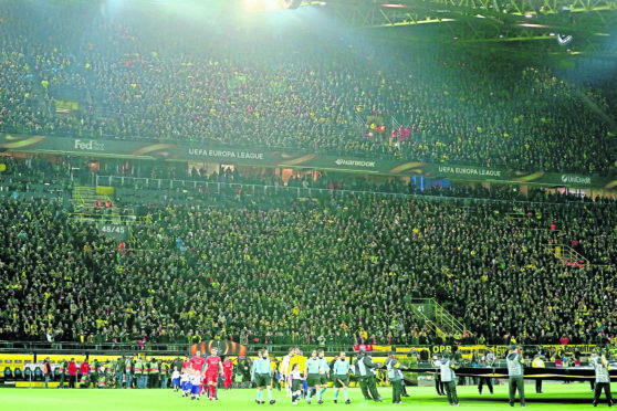 Borussia Dortmund and Liverpool make their way out on to the pitch at the impressive Westfalenstadion in Dortmund.