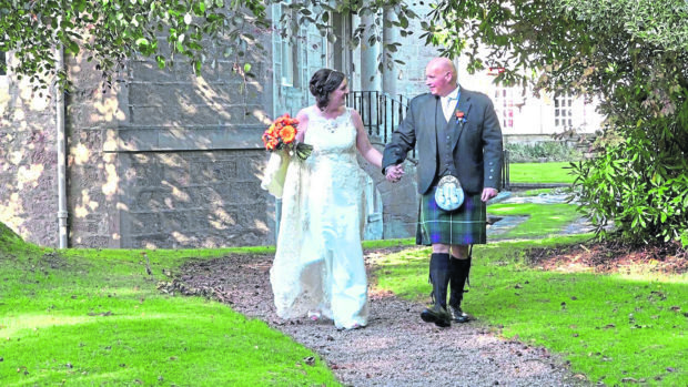 Newlyweds Sheree and James MacDonald take a stroll outside Nairn’s Newton Hotel.