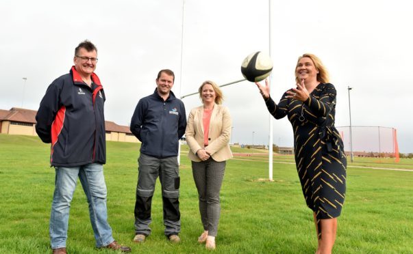 Alexander Davidson and Nicola Harris (centre) with Neil Davidson, secretary of Peterhead Rugby Club (left) and Councillor Dianne Beagrie.