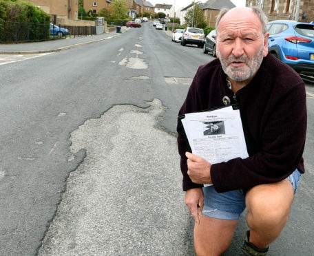 Phil Mills-Bishop with his pothole petition.