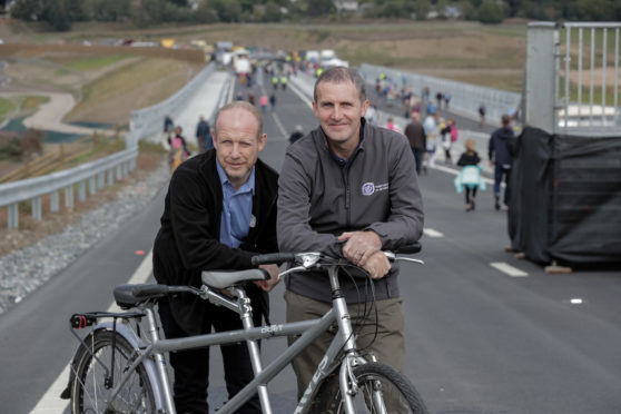 Scottish transport minister Michael Matheson on the new bypass before it officially opened with Neil Skene, co-ordinator north-east sensory services.