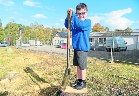Six-year-old James Roden, grandson of Tomatin Community Council chairwoman Vivienne Roden prepares to help with the construction of the villages new Community Hub.
Picture by Sandy McCook.