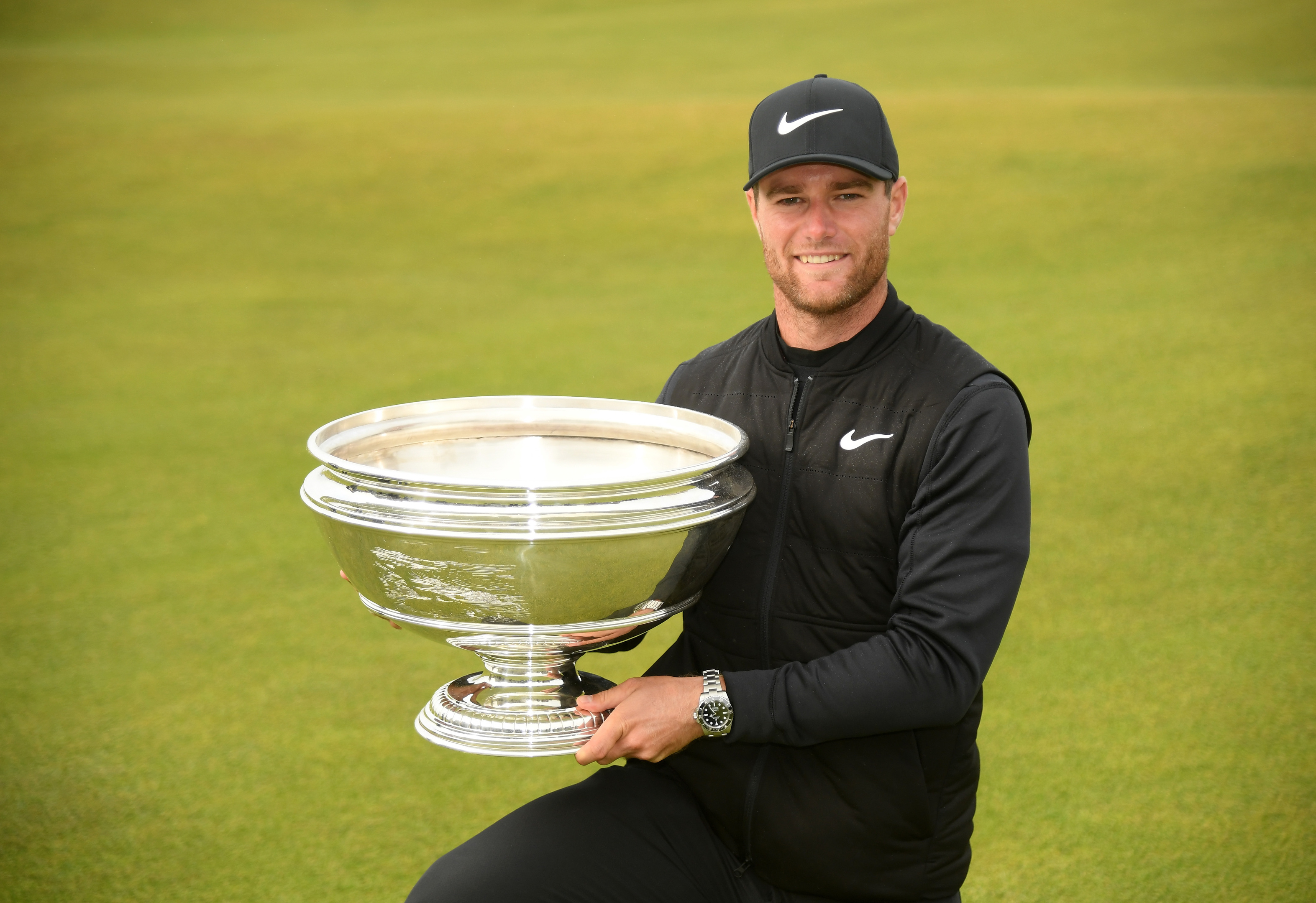 Lucas Bjerregaard of Denmark celebrates with the winners trophy following his victory