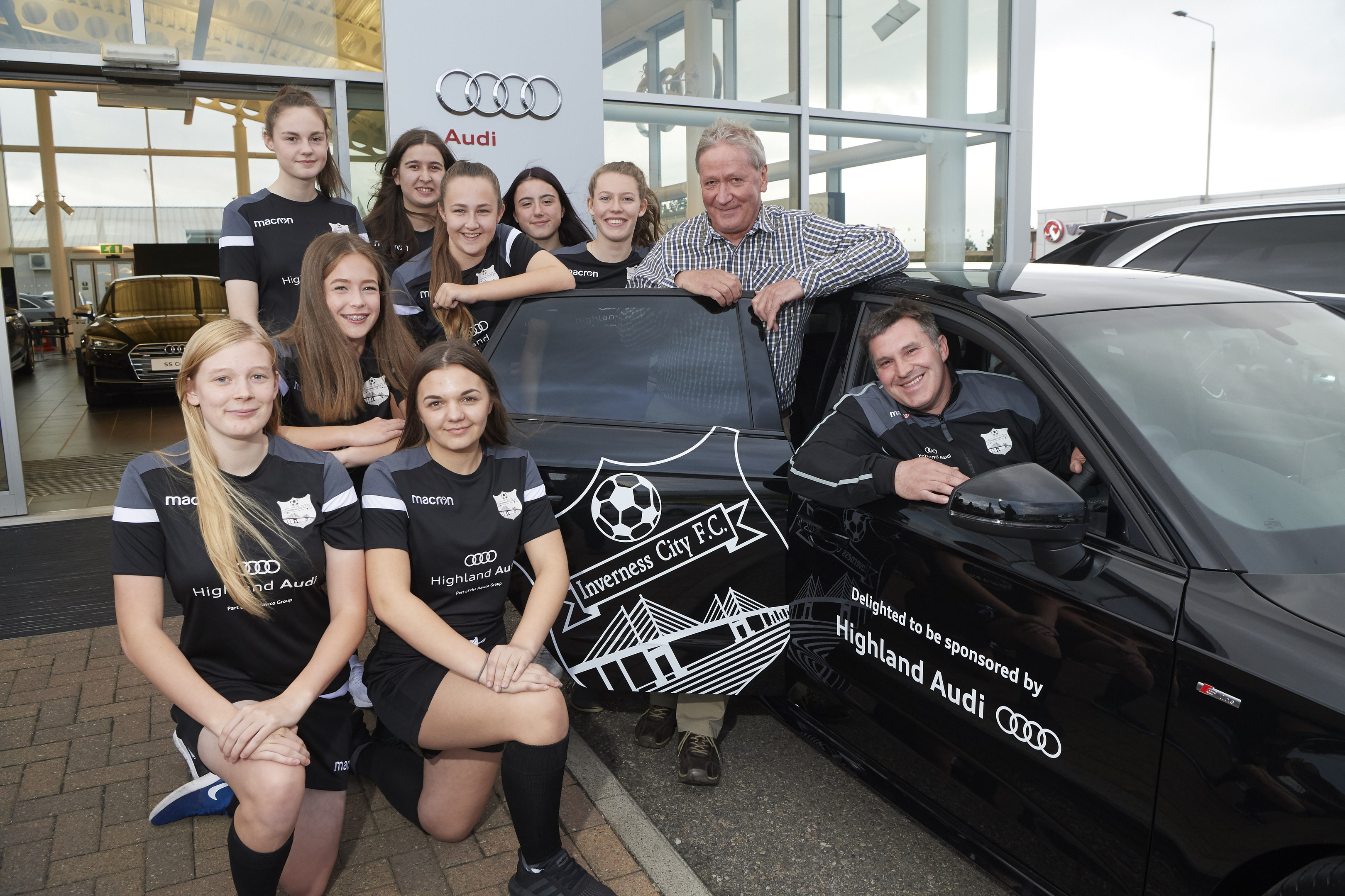 The girls in their new kit with John Hawco and coach Ally Munro.