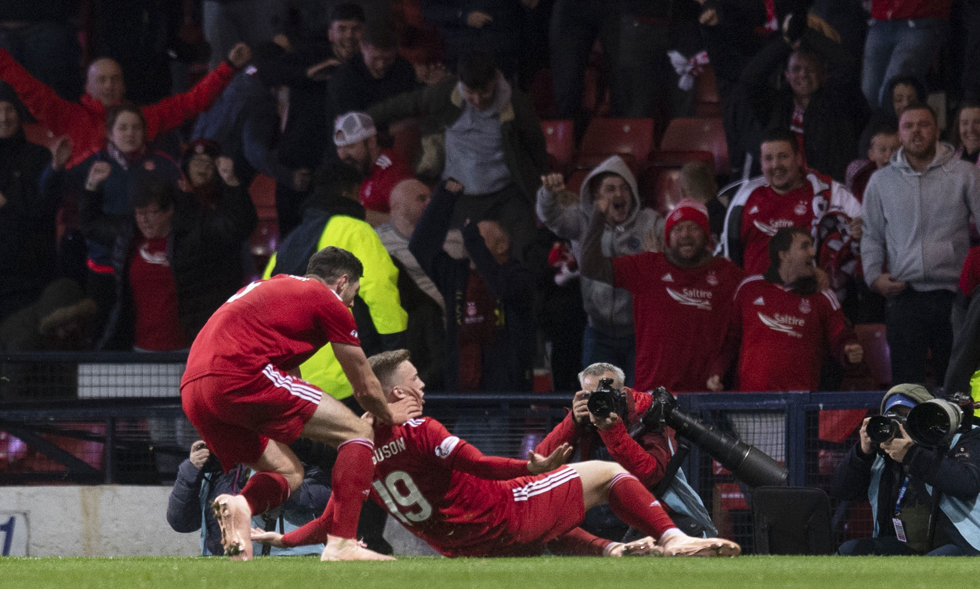 Lewis Ferguson celebrates his goal in front of the Aberdeen supporters.