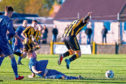 Auchinleck goalscorer Stephen Wilson evades the challenge of a frustrated Mitch Megginson in                                        the tense tie with Cove.