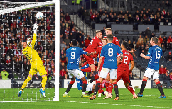 Fergie time: The Dons midfielder heads home the winner against Rangers.