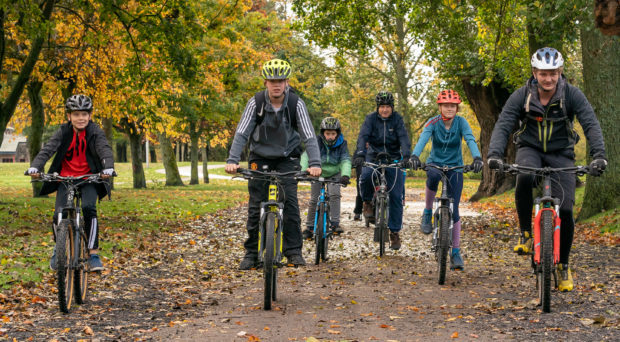 This is a scene from Bikefest as part of Elgin Youth Café’s Inspiration Week at Coper park, Elgin, Moray on Sunday 14 October 2018. Photographed by JASPERIMAGE ©. PICTURE CONTENT:- Right, David Brackpool of Outfir Moray, leads the Cyclist away from Cooper park to Lossiemouth.