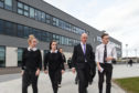 Deputy First Minister John Swinney is guided round Elgin High School by students Tilly Stewart, Abigail Isaacs and Fraser Duncan.