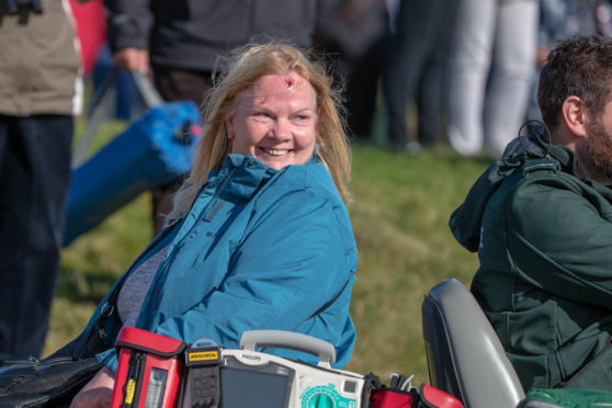 A spectator is taken away for treatment after being struck by a ball at Kingsbarns