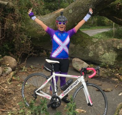 Louise Cruickshank at a fallen tree in the Borders.