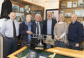 The model aircraft will be on display at the RAF heritage centre in Lossiemouth. Pictured: Warrant Officer Al Milligan, Jill Stephens, Anthony Stephens, retired Flt Lt Adrian Stephens, Nicola Stephens, Sgt John Le Huquet.