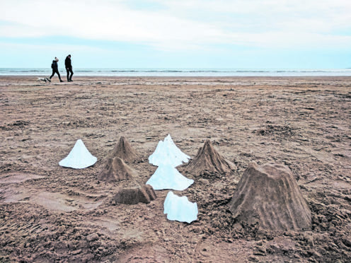 Artist Katie Paterson wants people to sculpt thousands of mountains of sand on north coastlines.