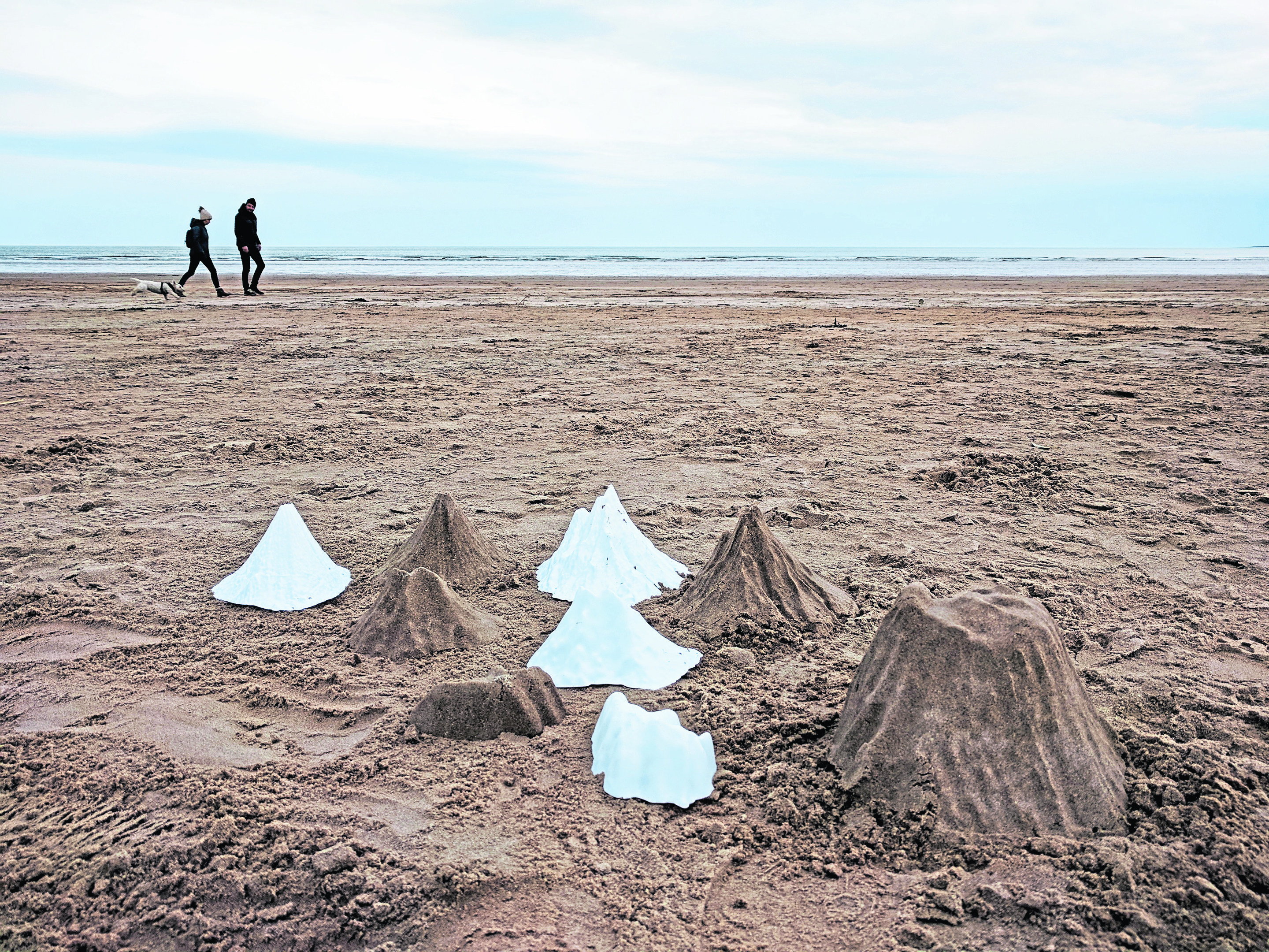 Artist Katie Paterson wants people to sculpt thousands of mountains of sand on north coastlines.