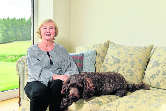 Bridget inside her home with her dog George.

Picture by Scott Baxter.