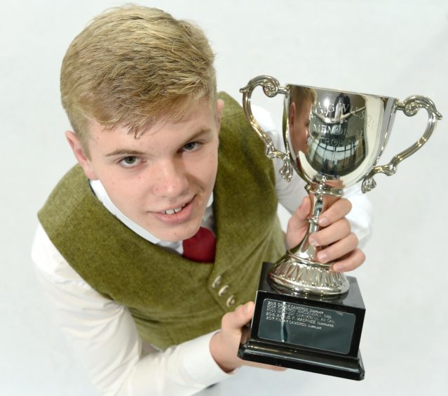 Gregor Macdonald of Oban High School with the WGG Wilson Trophy for Piobaireachd in the under 19 age category.