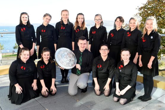 Dunoon 2018. Rionnagan Rois from throught Ross-shire, winners of the Queen Elizabeth (1937) Coronation Trophy being held by conductor Ross Brindle.