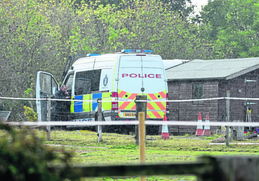 Police officers leave the Leanach Quarry site, Culloden yesterday afternoon following a search for Rennee MacRae and her son Andrew.
Picture by Sandy McCook.