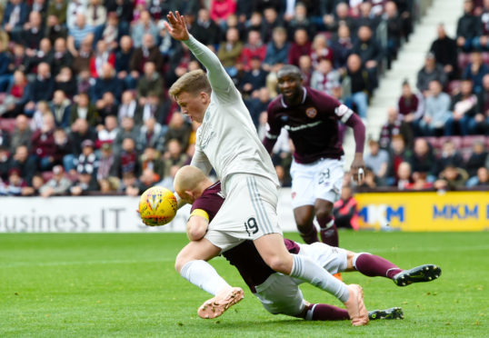 Lewis Ferguson was adjudged to have fouled Steven Naismith for Hearts' first penalty.