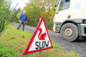 James Murray, chairman of the Strathnairn Community Council, with a warning sign for road drivers after a number of red squirrels have been killed on local roads.
Picture by Sandy McCook.