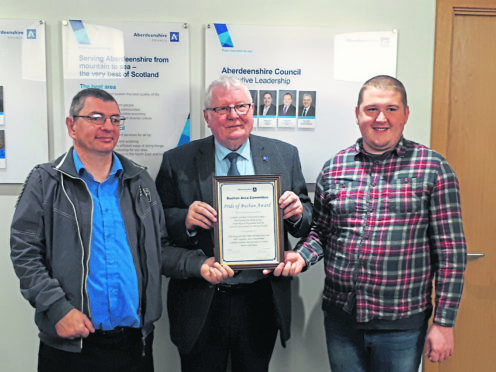 Councillor Norman Smith presenting representative from the group's involved with the Landale Gardens projects with their award.