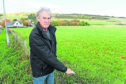 Fortrose Community Council Chairman, Tom Heath beside the field on the outskirts of Fortrose.