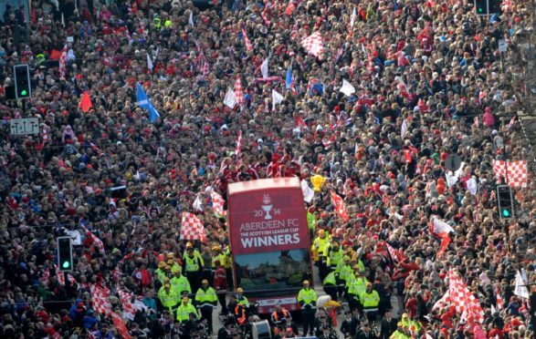 Aberdeen FC parade the Scottish League Cup trophy through the city centre after their 2014 triumph.