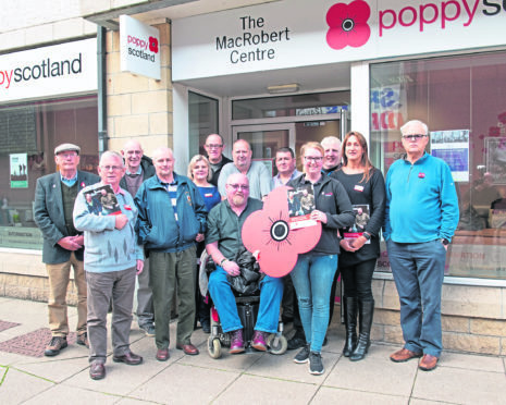 The pictures feature veterans and members of the Poppyscotland team at the Inverness Welfare Centre, holding aloft the Five-Year Impact Report. Picture:  Highland Dreams Photography.