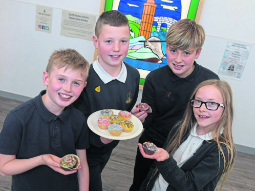 Turriff Primary School tea party to mark the first anniversary of their official opening. From left, Charlie Greig, Mathew Gove, Nicol Dall and Logan Dibben.
Picture by Kath Flannery.