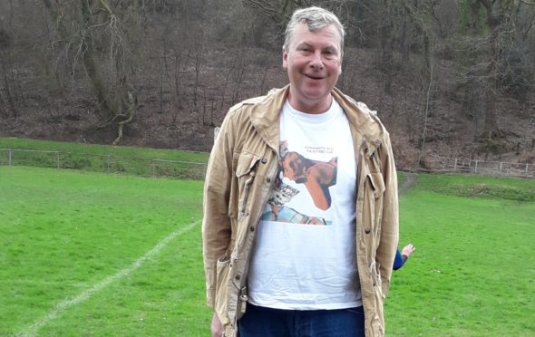 Football fan Mark Jones with his dog Bear at a friendly in Fort William earlier this year.