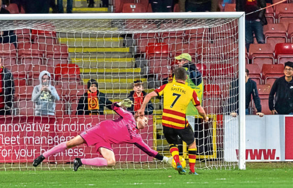 Caley Jags keeper Mark Ridgers dives to save Blair Spittal’s spot-kick.