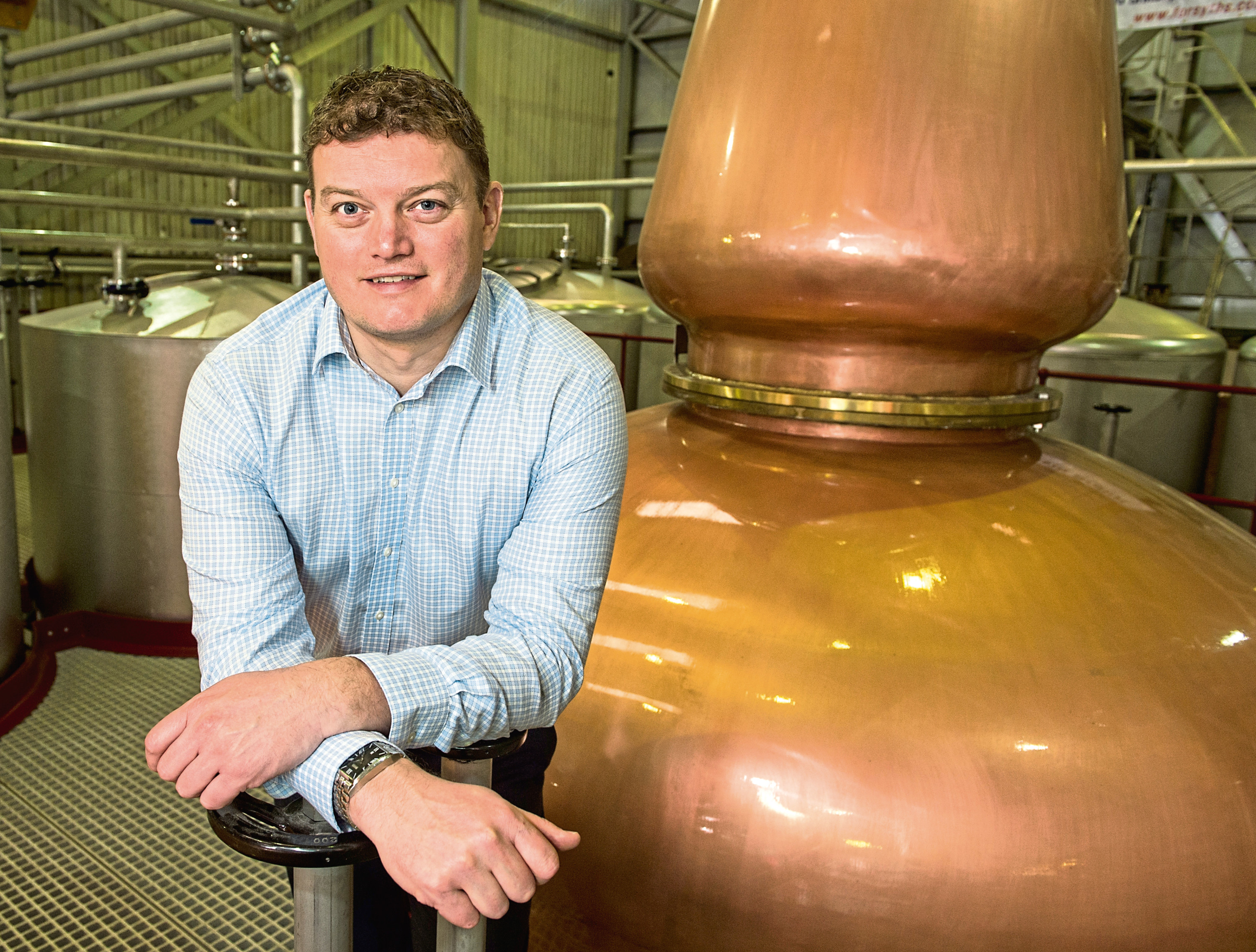 Richard Forsyth of Forsyths is pictured with the skid-mounted movable distillery in Marine Place.