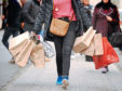 File photo dated 6/12/11 of a shopper carrying shopping bags. High street sales dropped by 2.2% last month in an "underwhelming" Christmas for many retailers, according to a report. ... High street sales ... 06-01-2014 ... London ... UK ... Photo credit should read: Dominic Lipinski/PA Wire. Unique Reference No. 18604411 ... Issue date: Monday January 6, 2014. Figures from accountancy firm BDO showed the sales surge hoped for by many shops failed to materialise in the crucial trading period, with like-for-like sales - excluding online trade - dropping by as much as 6.7% in the week to December 22. See PA story ECONOMY Retail. Photo credit should read: Dominic Lipinski/PA Wire