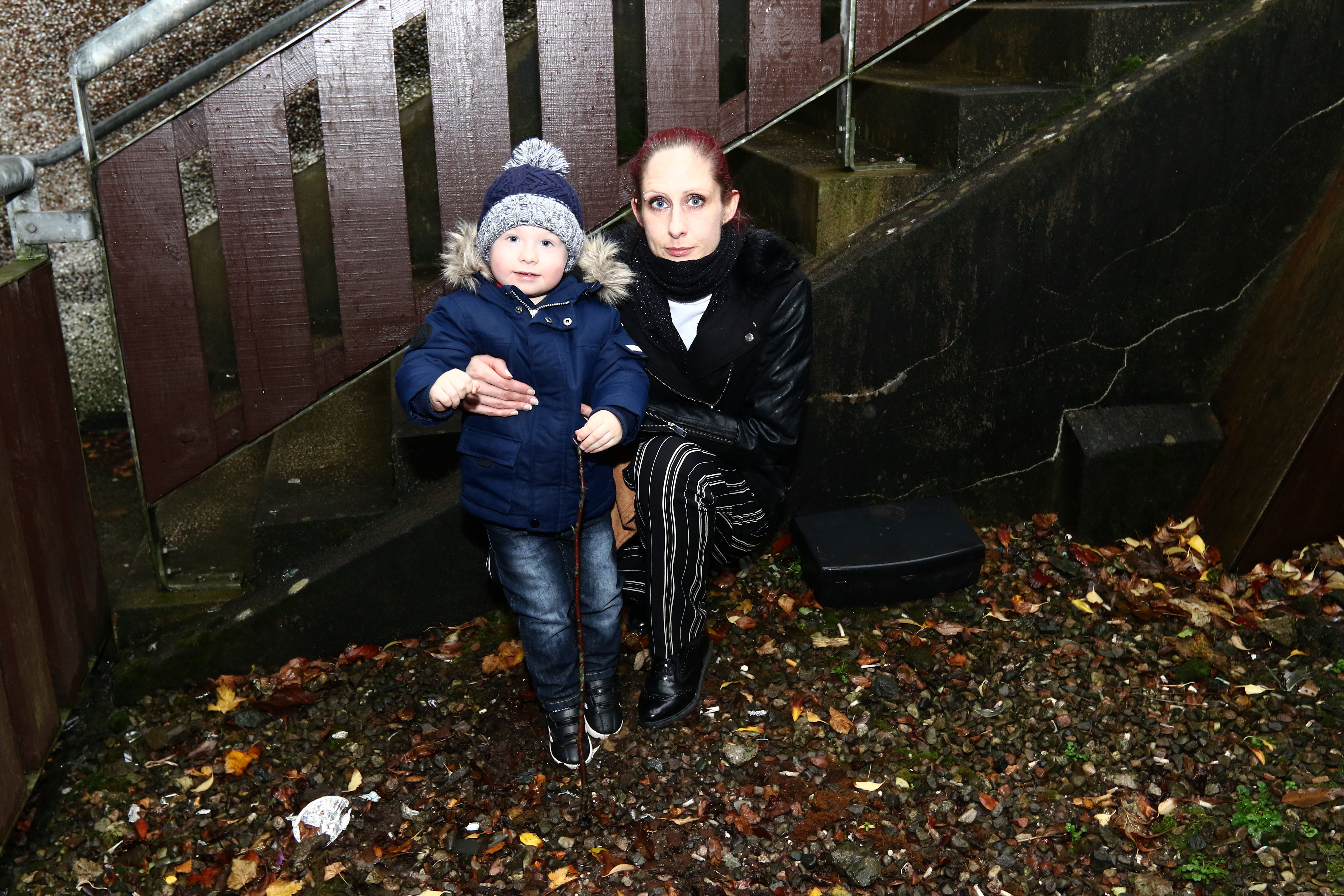 Alison McKnight and her son David Laird 2 near the rat traps at her home.
