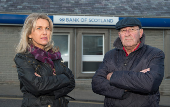 Lossiemouth Community Council vice-chairwoman Carolle Ralph and chairman Mike Mulholland outside Lossiemouth's Bank of Scotland branch.