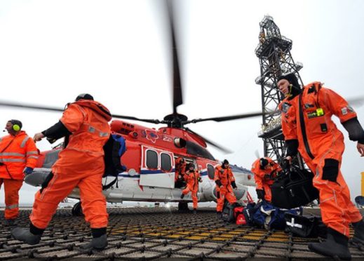 Offshore workers arrive on their platform by helicopter